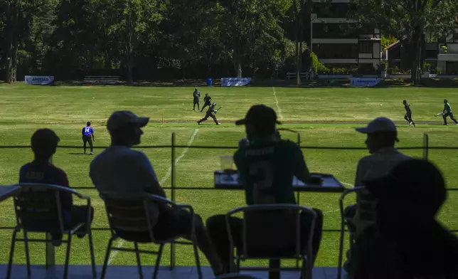 Spectators watch a cricket game by the Mexico State cricket team which is preparing for a national championship tournament, at Reforma Athletic Club in Mexico City, Sunday, June 16, 2024. (AP Photo/Fernando Llano)