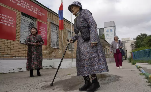 An elderly Mongolian woman arrives to vote at a polling station in Ulaanbaatar, Mongolia, Friday, June 28, 2024. Voters in Mongolia are electing a new parliament on Friday in their landlocked democracy that is squeezed between China and Russia, two much larger authoritarian states. (AP Photo/Ng Han Guan)