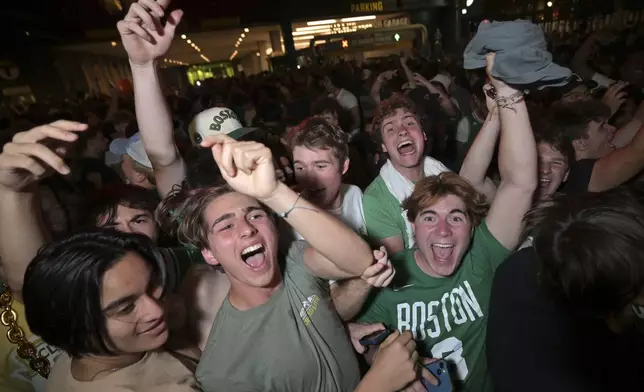 Boston Celtics fans react outside the TD Garden following the team's victory over the Dallas Mavericks in Game 5 of the NBA basketball finals in Boston Monday, June 17, 2024. (AP Photo/Josh Reynolds)