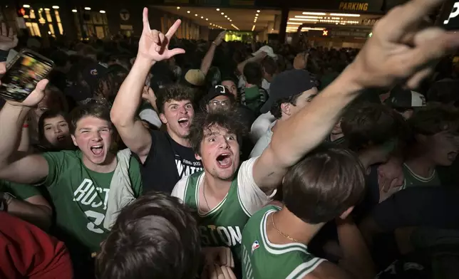 Boston Celtics fans react following the Celtics victory over the Dallas Mavericks in Game 5 of the NBA basketball finals in Boston on Monday, June 17, 2024. (AP Photo/Josh Reynolds)