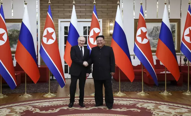Russian President Vladimir Putin, left, and North Korea's leader Kim Jong Un pose for a photo after the official welcome ceremony in Pyongyang, North Korea, on Wednesday, June 19, 2024. (Gavriil Grigorov, Sputnik, Kremlin Pool Photo via AP)