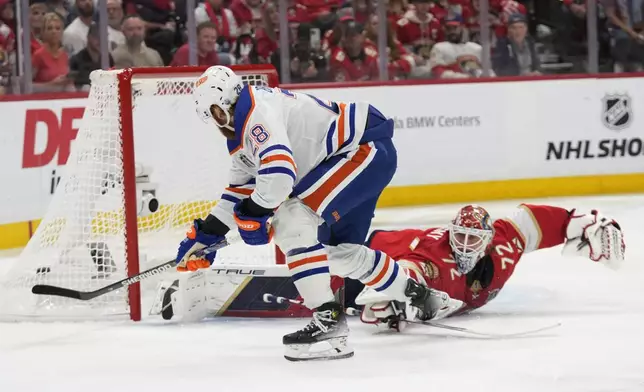 Edmonton Oilers right wing Connor Brown (28) scores a goal against Florida Panthers goaltender Sergei Bobrovsky (72) during the first period of Game 5 of the NHL hockey Stanley Cup Finals, Tuesday, June 18, 2024, in Sunrise, Fla. (AP Photo/Wilfredo Lee)