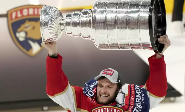 Florida Panthers forward Aleksander Barkov hoists the NHL hockey Stanley Cup after defeating the Edmonton Oilers in Sunrise, Fla., Monday, June 24, 2024. (Nathan Denette/The Canadian Press via AP)