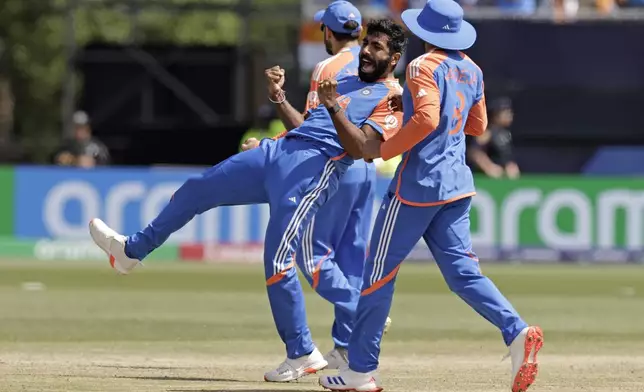 India's Jasprit Bumrah, center, celebrates the dismissal of Pakistan's Mohammad Rizwan during the ICC Men's T20 World Cup cricket match between India and Pakistan at the Nassau County International Cricket Stadium in Westbury, New York, Sunday, June 9, 2024. (AP Photo/Adam Hunger)