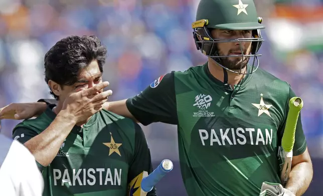 Pakistan's Shaheen Shah Afridi, right, consoles batting partner Naseem Shah as they leave the field after their loss in the ICC Men's T20 World Cup cricket match between India and Pakistan at the Nassau County International Cricket Stadium in Westbury, New York, Sunday, June 9, 2024. (AP Photo/Adam Hunger)