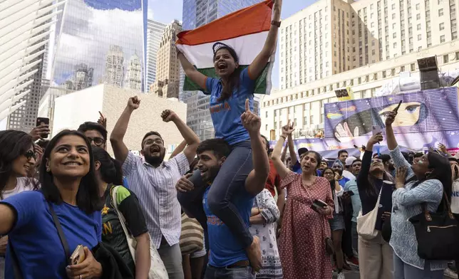 Fans of India celebrate at a viewing party for the ICC Men's T20 World Cup cricket match between India and Pakistan at The Oculus, Sunday, June 9, 2024, in New York. (AP Photo/Yuki Iwamura)