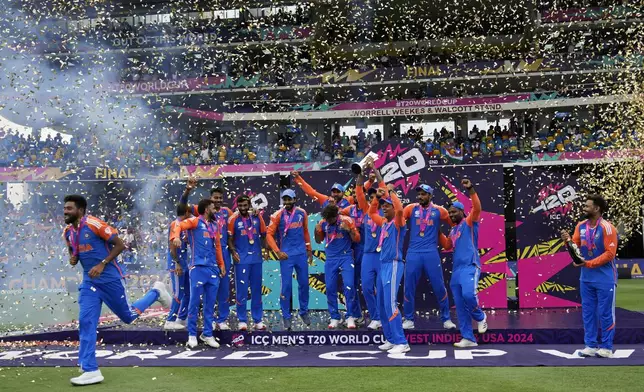 India's players celebrate with the winners' trophy after winning against South Africa in the ICC Men's T20 World Cup final cricket match at Kensington Oval in Bridgetown, Barbados, Saturday, June 29, 2024. (AP Photo/Ramon Espinosa)