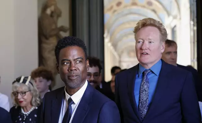 Chris Rock, left, and Conan O'Brien arrive for an audience with Pope Francis in the Clementine Hall at The Vatican, Friday, June 14, 2024. Pope Francis is meeting with over 100 comedians from 15 countries aiming to establish a link between the Catholic Church and comic artists. (AP Photo/Riccardo De Luca)