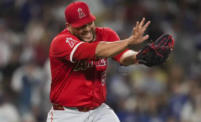 Los Angeles Angels relief pitcher Carlos Estévez celebrates after a 3-2 win over the Los Angeles Dodgers in a baseball game in Los Angeles, Friday, June 21, 2024. (AP Photo/Ashley Landis)