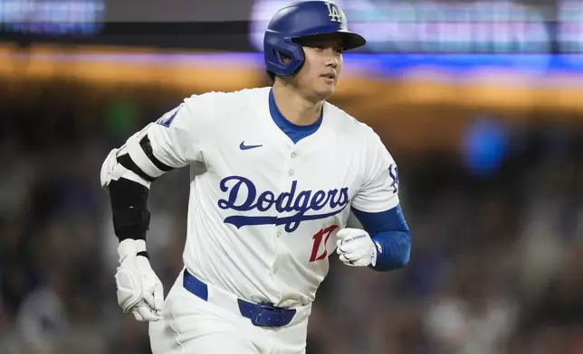 Los Angeles Dodgers designated hitter Shohei Ohtani runs the bases after hitting a home run during the fifth inning of a baseball game against the Los Angeles Angels in Los Angeles, Friday, June 21, 2024. Austin Barnes also scored. (AP Photo/Ashley Landis)