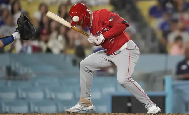 Los Angeles Angels' Taylor Ward (3) is hit by a pitch from Los Angeles Dodgers relief pitcher Yohan Ramírez (46) during the eighth inning of a baseball game in Los Angeles, Friday, June 21, 2024. (AP Photo/Ashley Landis)