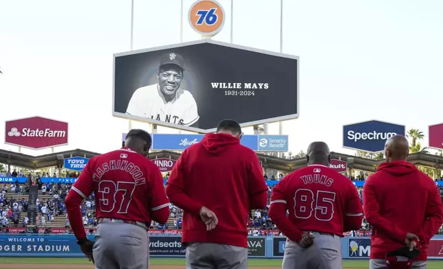 Los Angeles Angels players and coaches pause for a moment of silence for former MLB player Willie Mays before a baseball game against the Los Angeles Dodgers in Los Angeles, Friday, June 21, 2024. (AP Photo/Ashley Landis)