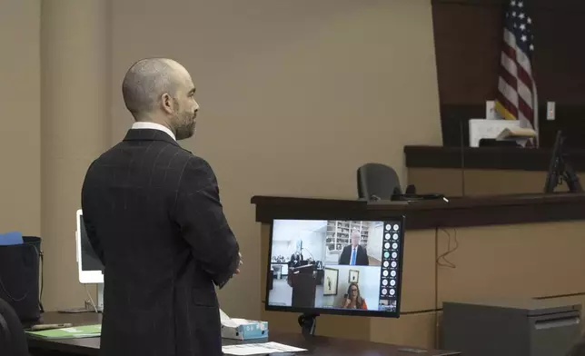 Arizona Attorney General Criminal Division Chief Nick Klingerman, left, speaks during the video arraignment Mark Meadows, top right on monitor, former Chief of Staff to President Donald Trump, Friday, June 7, 2024, in Maricopa County Superior Court in Phoenix. Meadows pleaded not guilty Friday to nine felony charges for his role in an effort to overturn Trump's Arizona election loss to Joe Biden. (Mark Henle/The Arizona Republic via AP)