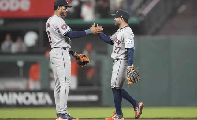 Houston Astros shortstop Jeremy Peña, left, celebrates with second baseman Jose Altuve after the Astros defeated the San Francisco Giants in a baseball game in San Francisco, Tuesday, June 11, 2024. (AP Photo/Jeff Chiu)