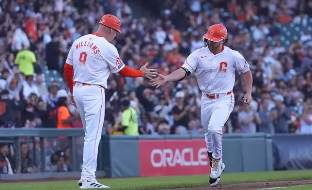 San Francisco Giants' Brett Wisely, right, is congratulated by third base coach Matt Williams after hitting a home run against the Houston Astros during the third inning of a baseball game in San Francisco, Tuesday, June 11, 2024. (AP Photo/Jeff Chiu)