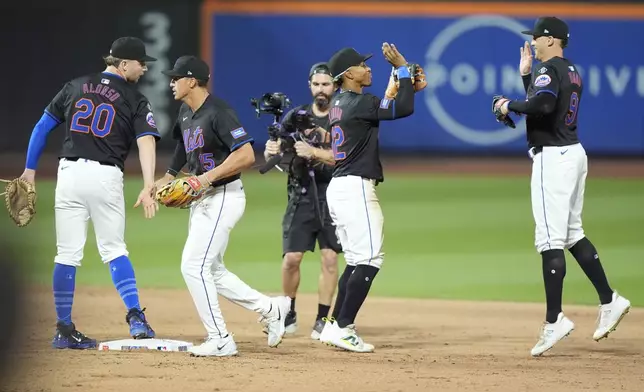 New York Mets' Pete Alonso (20) celebrates with Tyrone Taylor (15), Francisco Lindor (12) and Brandon Nimmo (9) after a baseball game against the Houston Astros, Friday, June 28, 2024, in New York. (AP Photo/Frank Franklin II)