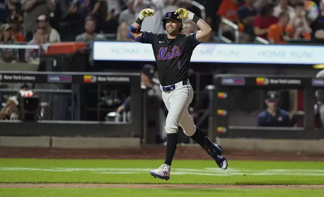 New York Mets' Jeff McNeil gestures as he runs the bases after hitting a three-run home run during the sixth inning of a baseball game against the Houston Astros, Friday, June 28, 2024, in New York. (AP Photo/Frank Franklin II)