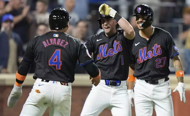 New York Mets' Jeff McNeil (1) celebrates with Francisco Alvarez (4) and Mark Vientos (27) after they scored on a three-run home run by McNeil against the Houston Astros during the sixth inning of a baseball game Friday, June 28, 2024, in New York. (AP Photo/Frank Franklin II)
