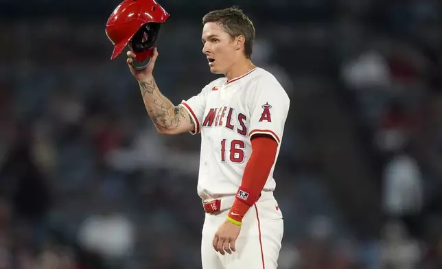 Los Angeles Angels' Mickey Moniak gestures after advancing to second on a wild pitch by Oakland Athletics starting pitcher Mitch Spence during the sixth inning of a baseball game Tuesday, June 25, 2024, in Anaheim, Calif. (AP Photo/Ryan Sun)