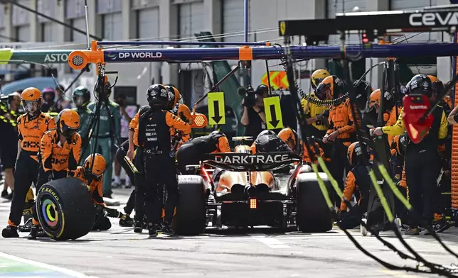 McLaren driver Lando Norris of Britain gets a pit service during the Austrian Formula One Grand Prix race at the Red Bull Ring racetrack in Spielberg, Austria, Sunday, June 30, 2024. (AP Photo/Christian Bruna, Pool)