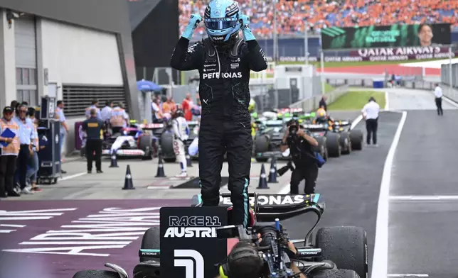Mercedes driver George Russell of Britain celebrates after winning the Austrian Formula One Grand Prix race at the Red Bull Ring racetrack in Spielberg, Austria, Sunday, June 30, 2024. (AP Photo/Christian Bruna)