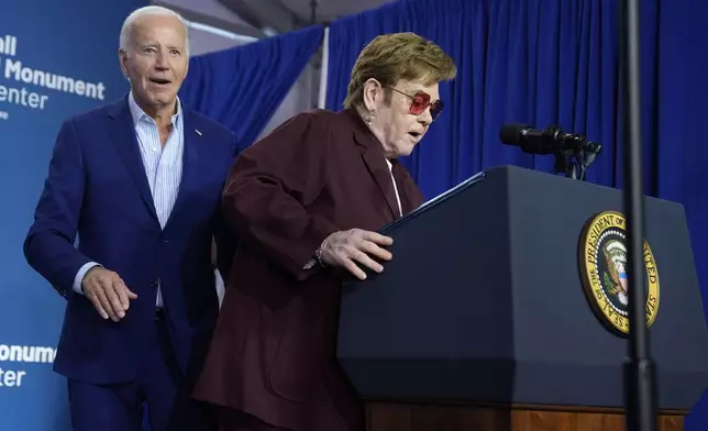 Elton John, right, prepares to speak as President Joe Biden looks on at the grand opening ceremony for the Stonewall National Monument Visitor Center, Friday, June 28, 2024, in New York. (AP Photo/Evan Vucci)