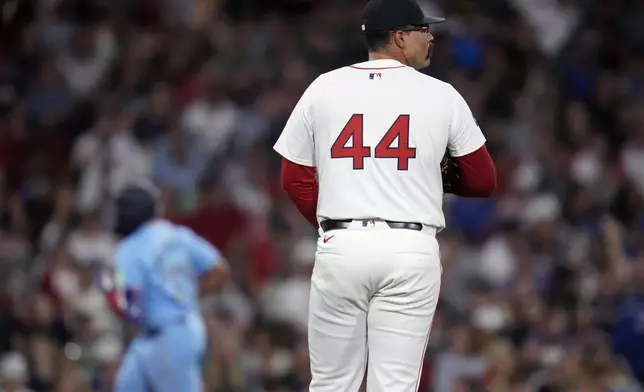 Boston Red Sox pitcher Isaiah Campbell (44) waits for Toronto Blue Jays' Vladimir Guerrero Jr. to round the bases, after Guerrero's three-run home run, during the seventh inning of a baseball game against the Boston Red Sox at Fenway Park, Monday, June 24, 2024, in Boston. (AP Photo/Charles Krupa)