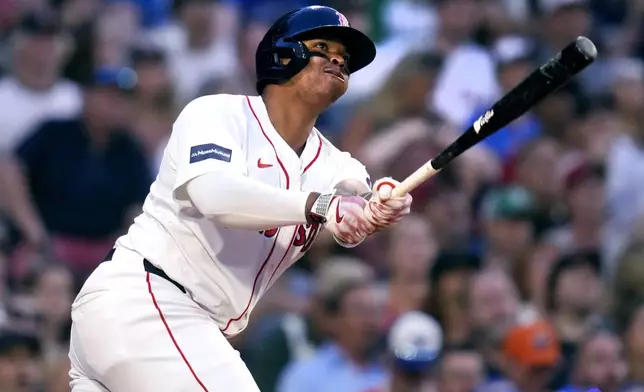 Boston Red Sox's Rafael Devers watches his two-run home run in the fourth inning of a baseball game against the Toronto Blue Jays at Fenway Park, Monday, June 24, 2024, in Boston. (AP Photo/Charles Krupa)