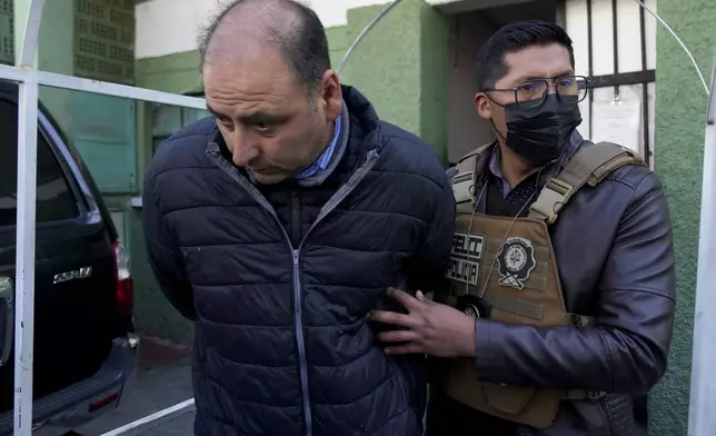 Colonel Edison Alejandro Caero, detained for his involvement in what President Luis Arce called a coup attempt, is escorted from a jail to be taken to Chonchocoro maximum security prison, in La Paz, Bolivia, Saturday, June 29, 2024. (AP Photo/Juan Karita)