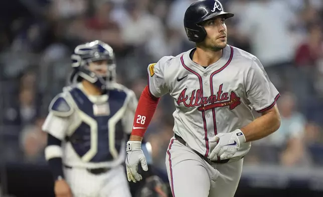 Atlanta Braves' Matt Olson watches his two-run home run, near New York Yankees catcher Jose Trevino during the fourth inning of a baseball game, Friday, June 21, 2024, in New York. (AP Photo/Frank Franklin II)