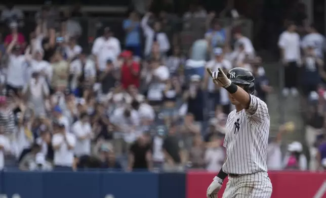 New York Yankees' Anthony Volpe celebrates hitting a double leading to Trent Grisham scoring during the sixth inning of a baseball game against the Atlanta Braves, Sunday, June 23, 2024, in New York. (AP Photo/Pamela Smith)