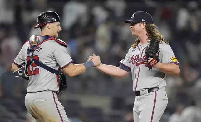 Atlanta Braves catcher Sean Murphy, left, celebrates with pitcher Grant Holmes, right, after a baseball game against the New York Yankees, Friday, June 21, 2024, in New York. (AP Photo/Frank Franklin II)