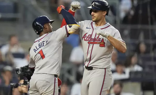 Atlanta Braves' Matt Olson, right, celebrates with Ozzie Albies after they scored on a home run by Olson against the New York Yankees during the fourth inning of a baseball game Friday, June 21, 2024, in New York. (AP Photo/Frank Franklin II)