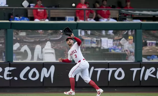 Los Angeles Angels left fielder Taylor Ward catches a fly ball hit by Milwaukee Brewers' Willy Adames during the first inning of a baseball game, Tuesday, June 18, 2024, in Anaheim, Calif. (AP Photo/Ryan Sun)