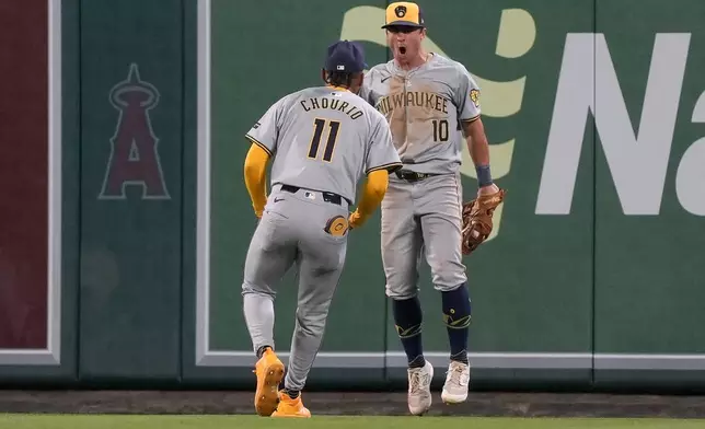 Milwaukee Brewers center fielder Sal Frelick, right, celebrates with right fielder Jackson Chourio after catching a fly ball hit by Los Angeles Angels' Taylor Ward for the final out of a baseball game, Tuesday, June 18, 2024, in Anaheim, Calif. (AP Photo/Ryan Sun)