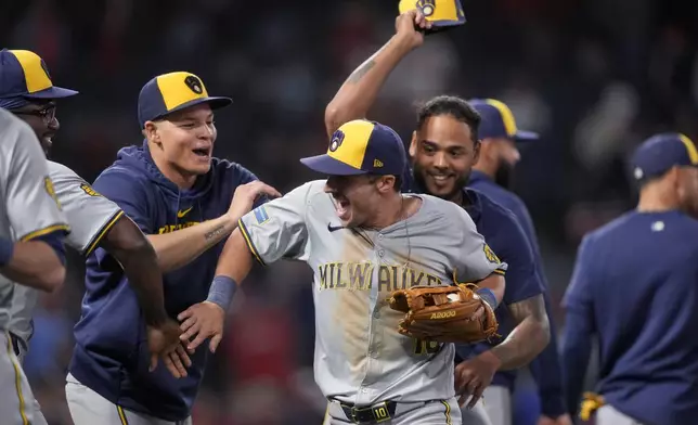 Milwaukee Brewers center fielder Sal Frelick celebrates with teammates after catching a fly ball hit by Los Angeles Angels' Taylor Ward for the final out of a baseball game, Tuesday, June 18, 2024, in Anaheim, Calif. (AP Photo/Ryan Sun)