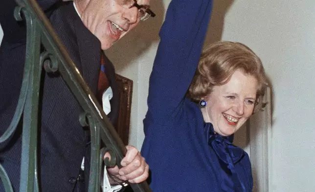 FILE - Britain's Conservative Party Leader Margaret Thatcher with her husband Dennis gives a jubilant wave at her party headquarters on election night in London, May 4, 1979. Britain’s upcoming general election on July 4, 2024, is widely expected to lead to a change of government for the first time in 14 years. Britain's general election in 1979 is without doubt the most consequential since 1945, with Margaret Thatcher becoming the country’s first female prime minister on a radical Conservative economic agenda. At its heart, Thatcherism represented a total rethink over the role of the state. (AP Photo/Bob Dear, File)