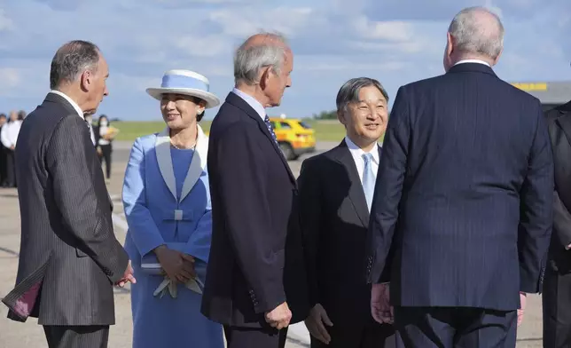 Emperor Naruhito and Empress Masako are greeted by dignitaries as they arrive at Stansted Airport, England, Saturday, June 22, 2024, ahead of a state visit. The state visit begins Tuesday, when King Charles III and Queen Camilla will formally welcome the Emperor and Empress before taking a ceremonial carriage ride to Buckingham Palace. (AP Photo/Kin Cheung)