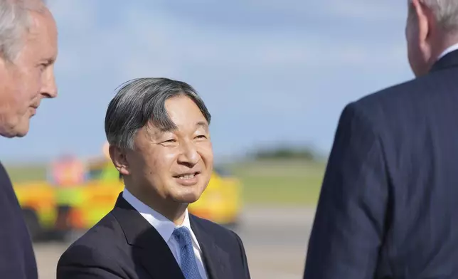 Emperor Naruhito is greeted by dignitaries has he and Empress Masako arrive at Stansted Airport, England, Saturday, June 22, 2024, ahead of a state visit. The state visit begins Tuesday, when King Charles III and Queen Camilla will formally welcome the Emperor and Empress before taking a ceremonial carriage ride to Buckingham Palace. (AP Photo/Kin Cheung)