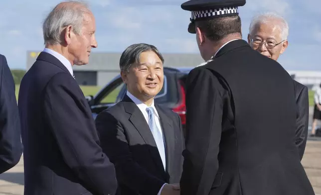 Emperor Naruhito is greeted by dignities as he and Empress Masako arrive at Stansted Airport, England, Saturday, June 22, 2024, ahead of a state visit. The state visit begins Tuesday, when King Charles III and Queen Camilla will formally welcome the Emperor and Empress before taking a ceremonial carriage ride to Buckingham Palace. (AP Photo/Kin Cheung)