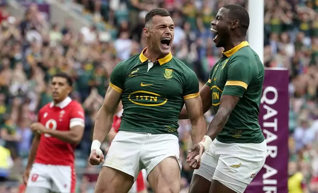 South Africa's Jesse Kriel, left, celebrates scoring during the rugby union cup match between Wales and South Africa at Twickenham Stadium, London, Saturday June 22, 2024. (Andrew Matthews/PA via AP)