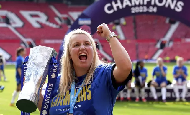 Chelsea manager Emma Hayes celebrates with the trophy after winning the English Women's Super League soccer match between Manchester United and Chelsea at Old Trafford, in Manchester, England, Saturday, May 18, 2024. (Martin Rickett/PA via AP)