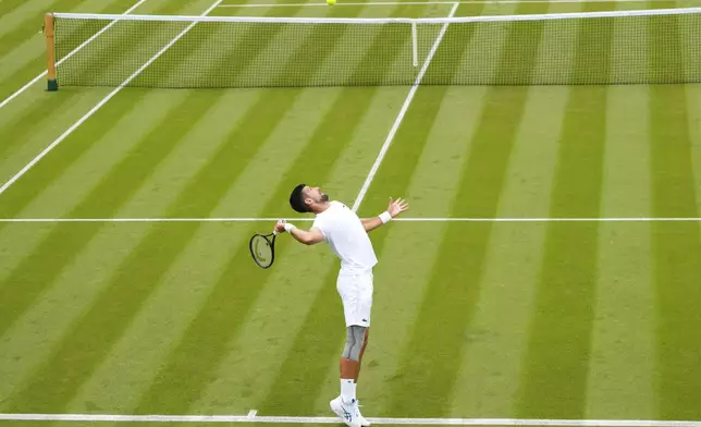 Novak Djokovic of Serbia serves during a training session on Court 2 at the All England Lawn Tennis and Croquet Club in Wimbledon, London, Friday, June 28, 2024. The Wimbledon Championships begin on July 1. (AP Photo/Kirsty Wigglesworth)