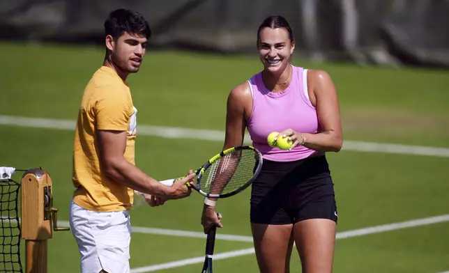 Carlos Alcaraz and Aryna Sabalenka practicing at the All England Lawn Tennis and Croquet Club in Wimbledon ahead of the Wimbledon Championships, which begins on July 1st, Wednesday June 26, 2024. (John Walton//PA via AP)