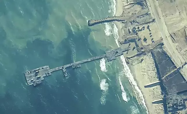 FILE - This image provided by U.S. Central Command, shows the U.S.-built floating pier being used to facilitate aid deliveries to the Gaza Strip, May 16, 2024. U.S. officials said Friday, June 14, 2024, that the pier will be detached from Gaza’s coast for the second time in a month due to rough seas, raising questions about the viability of the sea route. (U.S. Central Command via AP, File)