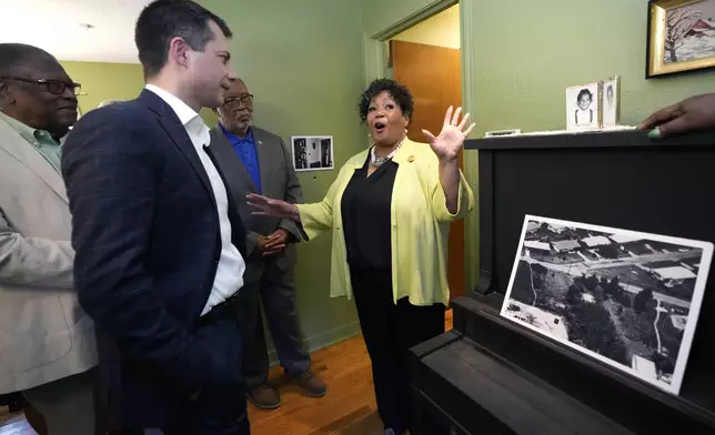 U.S. Transportation Secretary Pete Buttigieg, left, listens as Reena Evers-Everette, recalls her mother Myrlie Evers playing the piano when she was a small child, as a group of dignitaries toured the home of assassinated civil rights leader Medgar Evers, Friday, June 21, 2024, in Jackson, Miss. The house, the Medgar and Myrlie Evers National Monument, was one of the stops Buttigieg made as he spent Thursday and Friday in Mississippi, promoting projects that are receiving money or will be helped from a federal infrastructure act. (AP Photo/Rogelio V. Solis, Pool)