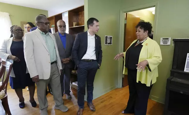 U.S. Transportation Secretary Pete Buttigieg, second from right, U.S. Rep. Bennie Thompson, D-Miss., second from left, and Mississippi Transportation Commissioner for the Central District Willie Simmons, left, listen as Reena Evers-Everette, speaks about her life as a young child in the home of assassinated civil rights leader Medgar Evers, Friday, June 21, 2024, in Jackson, Miss. The house, the Medgar and Myrlie Evers National Monument, was one of the stops Buttigieg made as he spent Thursday and Friday in Mississippi, promoting projects that will be helped or will be receiving money from a federal infrastructure act. (AP Photo/Rogelio V. Solis, Pool)