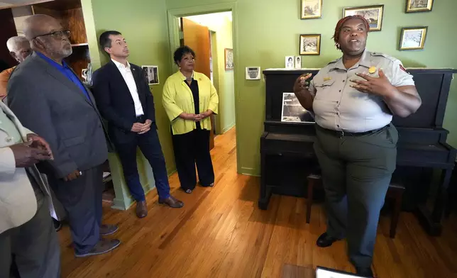 U.S. Rep. Bennie Thompson, D-Miss., left, U.S. Transportation Secretary Pete Buttigieg, second from left, Reena Evers-Everette, center, listen as Keena Graham of the National Park Service, right, speaks about the home of assassinated civil rights leader Medgar Evers, Friday, June 21, 2024, in Jackson, Miss. The house, the Medgar and Myrlie Evers National Monument, was one of the stops Buttigieg made as he spent Thursday and Friday in Mississippi, promoting projects that will be helped or will be receiving money from a federal infrastructure act. (AP Photo/Rogelio V. Solis, Pool)