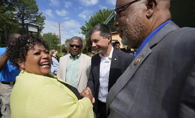 Reena Evers-Everette, left, daughter of assassinated civil rights leader Medgar Evers, left, welcomes U.S. Transportation Secretary Pete Buttigieg, second from right, Mississippi Transportation Commissioner for the Central District Willie Simmons, second from left, and U.S. Rep. Bennie Thompson, D-Miss., right, to the home of her father, assassinated civil rights leader Medgar Evers, Friday, June 21, 2024, in Jackson, Miss. (AP Photo/Rogelio V. Solis)