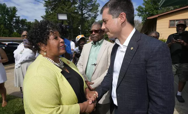 Reena Evers-Everette, front left, daughter of assassinated civil rights leader Medgar Evers, left, welcomes U.S. Transportation Secretary Pete Buttigieg, front right, and Mississippi Transportation Commissioner for the Central District Willie Simmons, center, to the home of her father, assassinated civil rights leader Medgar Evers, Friday, June 21, 2024, in Jackson, Miss. The house, now the Medgar and Myrlie Evers National Monument, was one of the stops Buttigieg made as he spent Thursday and Friday in Mississippi, promoting projects that will be helped or will be receiving money from a federal infrastructure act. (AP Photo/Rogelio V. Solis)